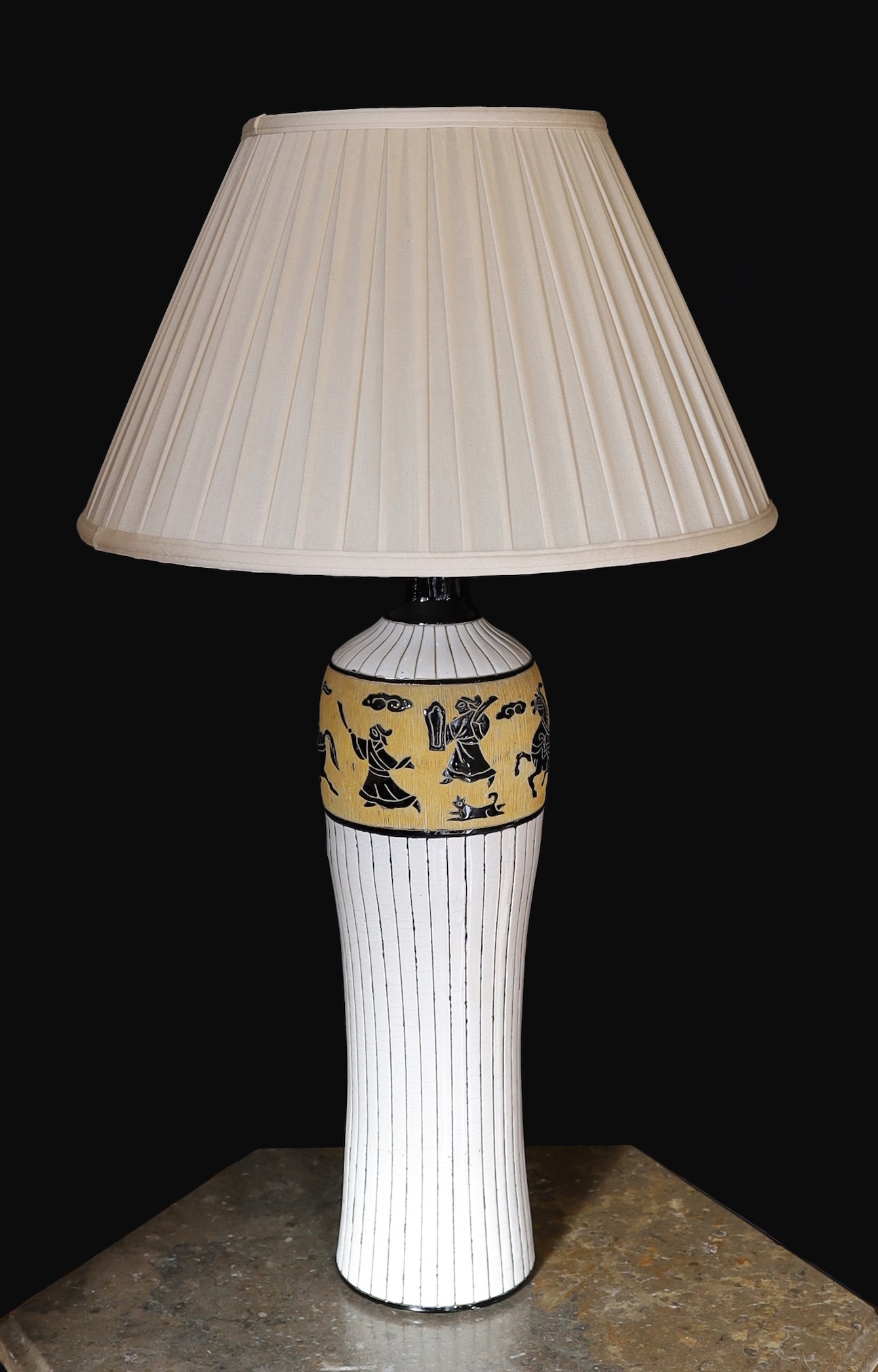A 20th century Continental tinglazed pottery table lamp, decorated within a band of horse riders and birds, height without shade 62cm